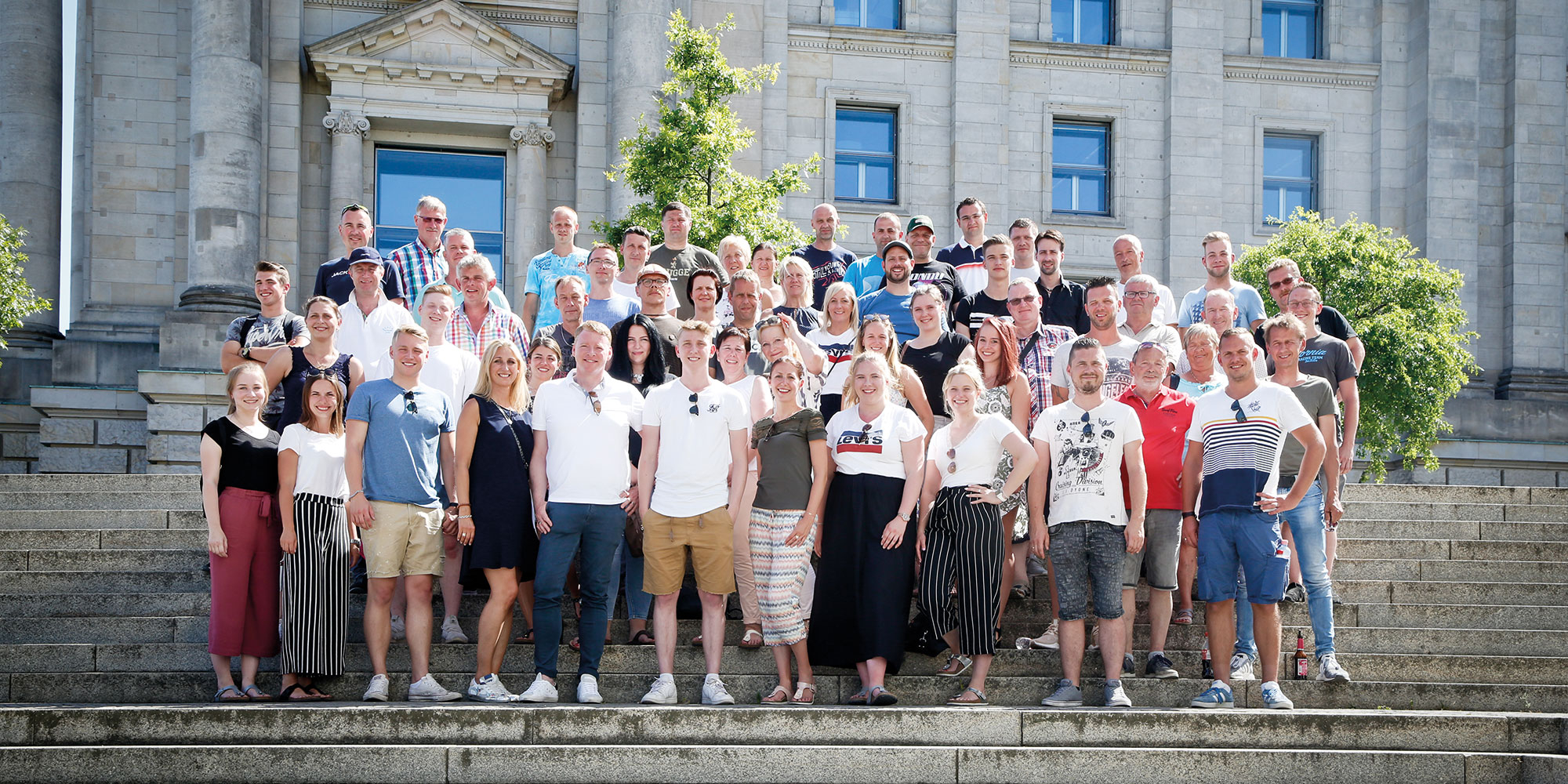 Teamfoto von allen Ewering Mitarbeitern auf einer Treppe